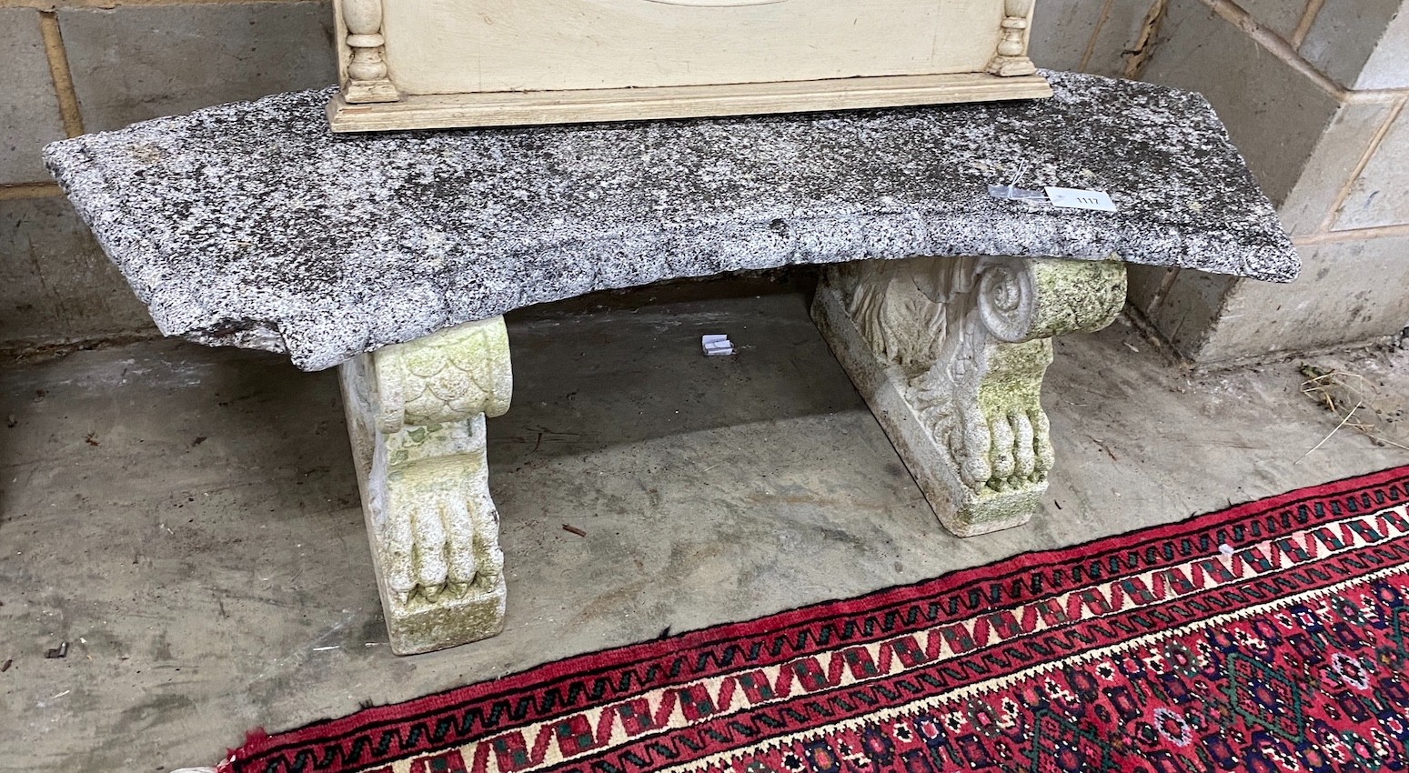 A white painted reconstituted stone curved garden seat, length 132cm, 40cm, height 44cm, Provenance- the late Maureen Marchioness of Dufferin and Ava, Owl House Gardens, Lamberhurst, Kent